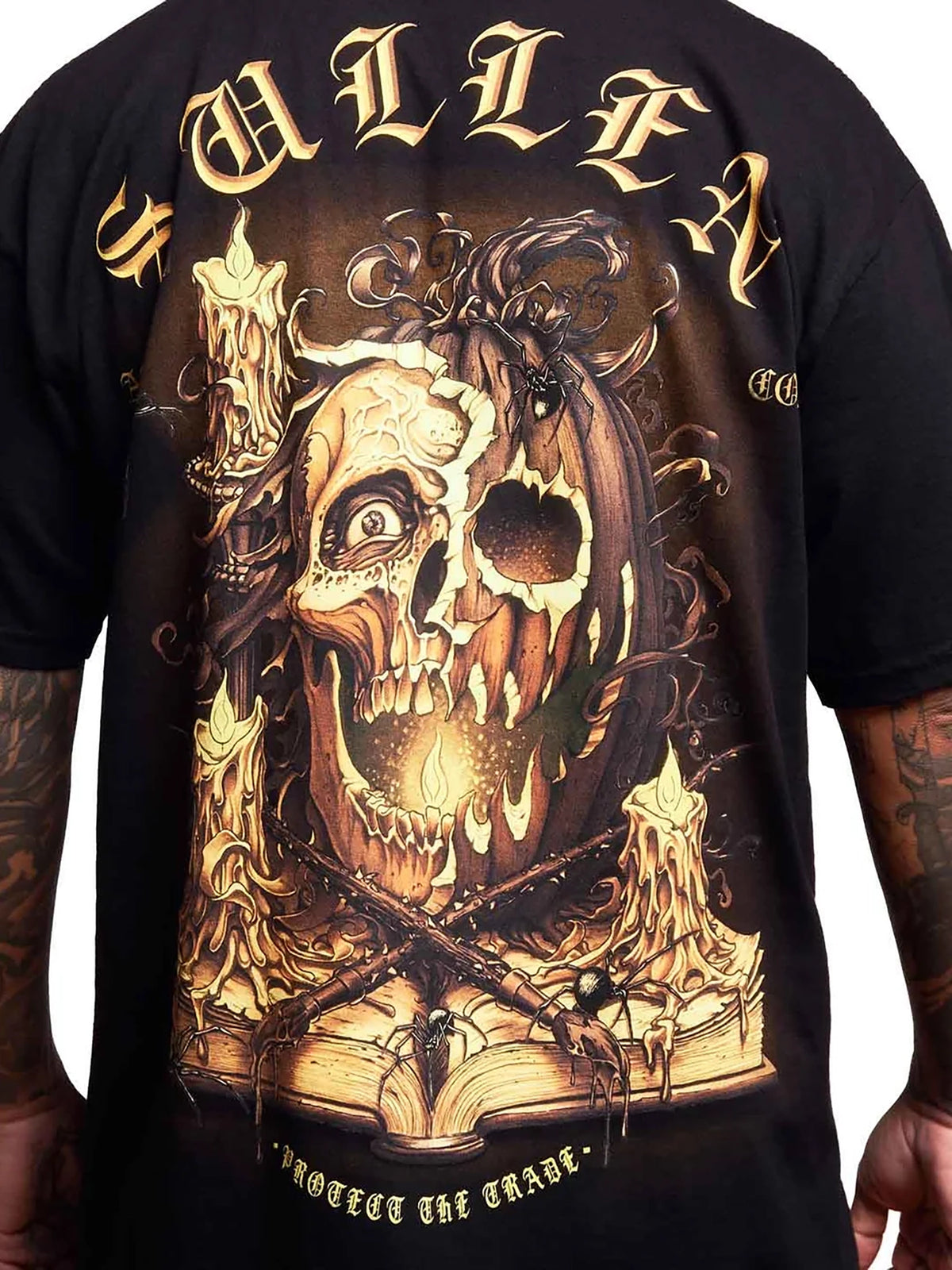 Close-up of the candlelit pumpkin and Protect the Trade back artwork on the Sullen Boo T-shirt