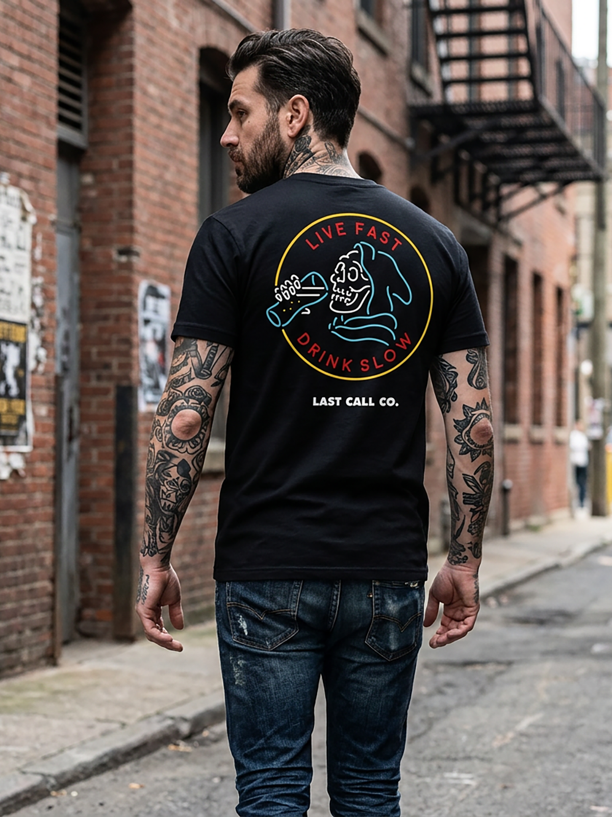Last Call Co Drink Slow Graphic T-Shirt Black lifestyle back view featuring skeleton and Drink Slow back graphic