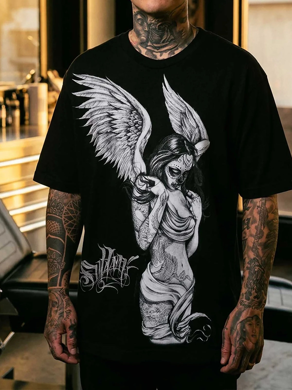 Tattooed model wearing the Sullen Fallen Angel oversized heavyweight black T-shirt