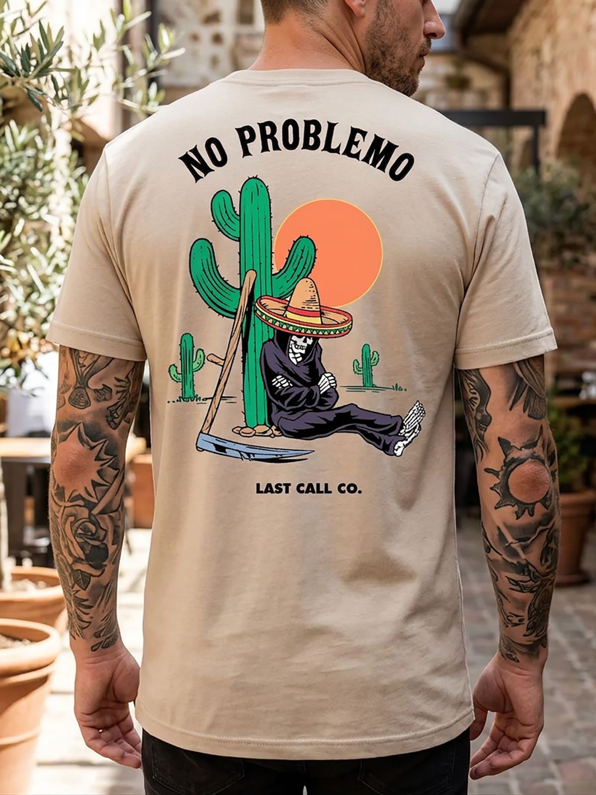 Last Call Co No Problemo Graphic T-Shirt Sand lifestyle back view featuring cowboy skull and No Problemo back graphic