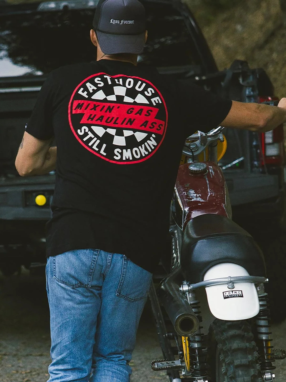 Fasthouse Men's Oil Burner Graphic T-shirt in Black, lifestyle view showing the back graphic