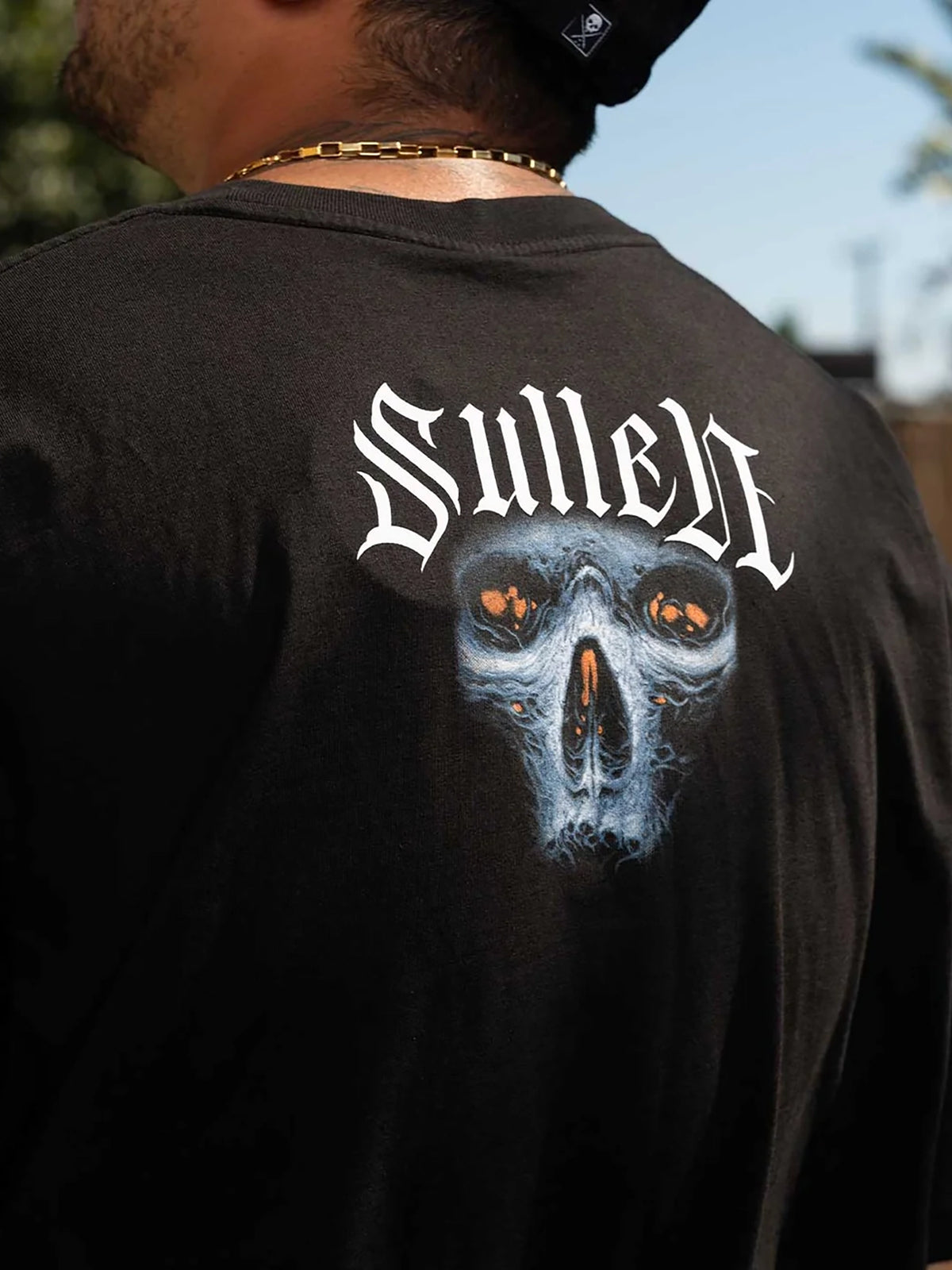 Styled back view of the Sullen Ruh Neb T-shirt with upper-back skull print