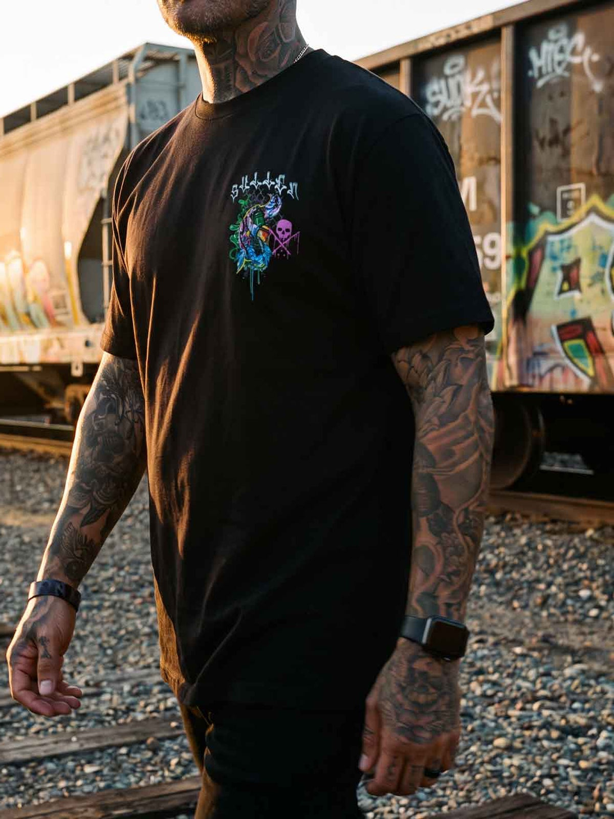 Styled front view of the Sullen Chemical Swirl Premium Tee beside a graffiti-covered train