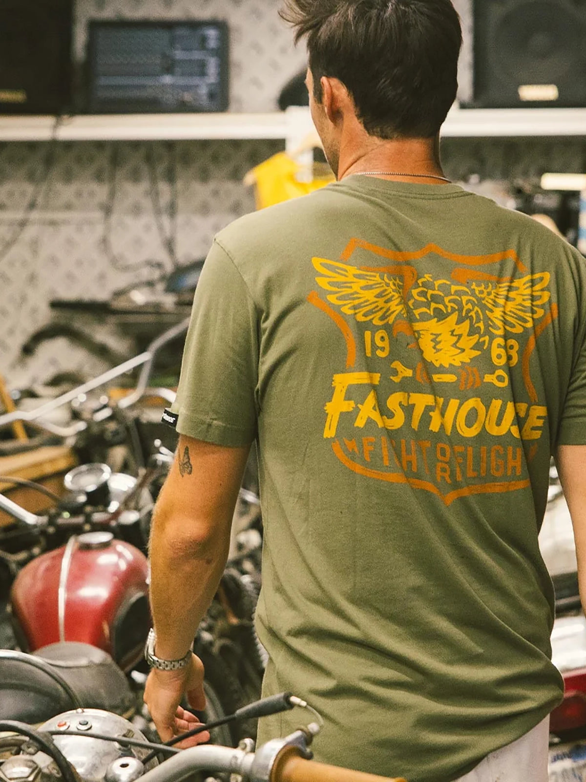 Fasthouse Men's Talon Graphic T-shirt in Olive, lifestyle view showing the back graphic