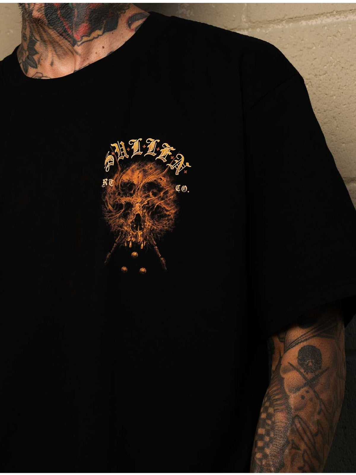 Styled front view of the Sullen Revenant Premium Jet Black T-shirt with small skull chest graphic