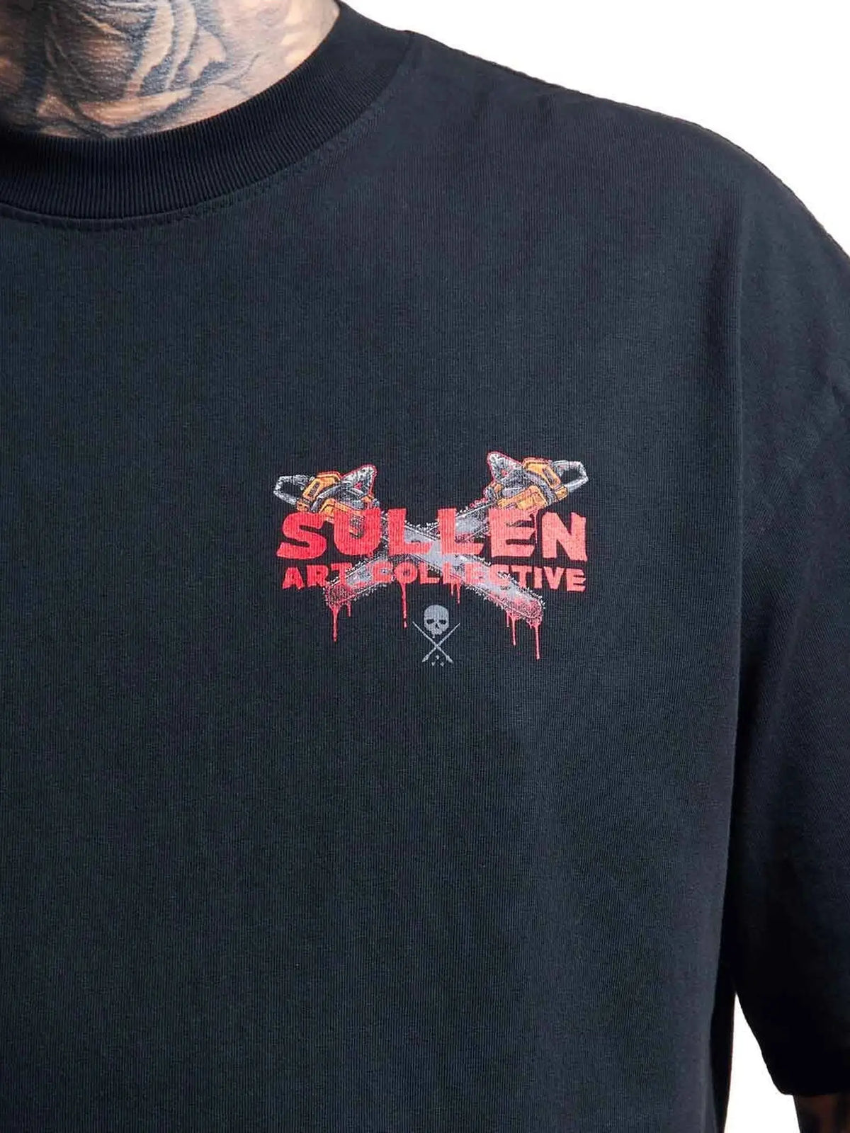 Close-up of the Sullen chainsaw chest graphic on the Chainsaw Badge T-shirt