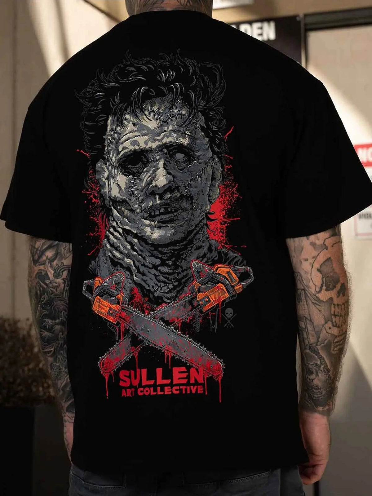 Styled back view of the Sullen Chainsaw Badge 1 Ton T-shirt