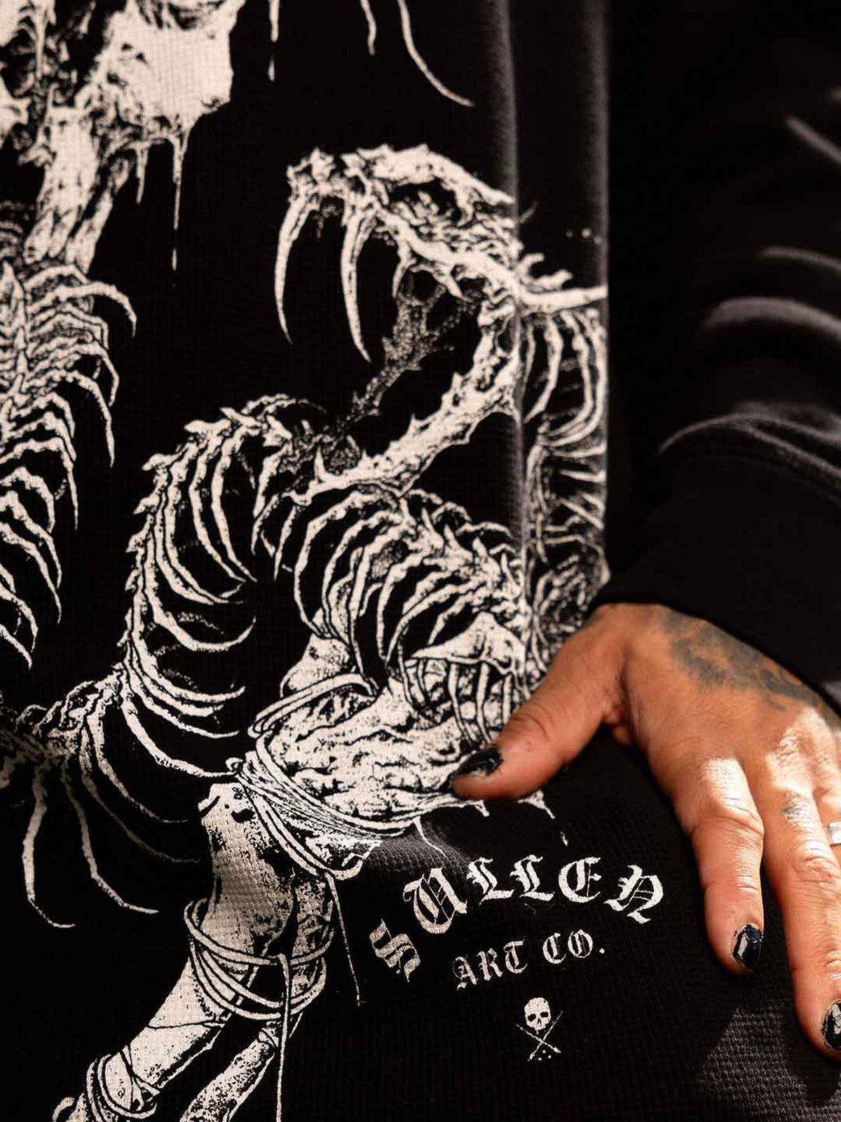 Sullen Cold Venom thermal, outdoor close-up of skeletal serpent print and waffle-knit fabric