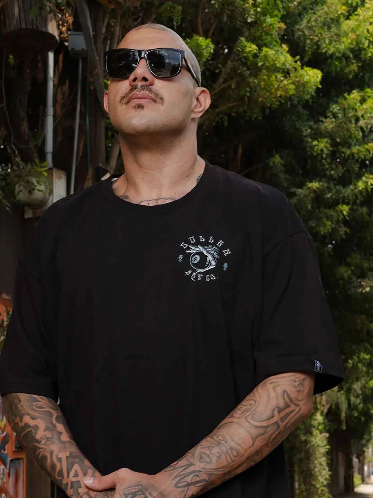 Model wearing the front of the Sullen Behind the 8 Standard T-shirt in black