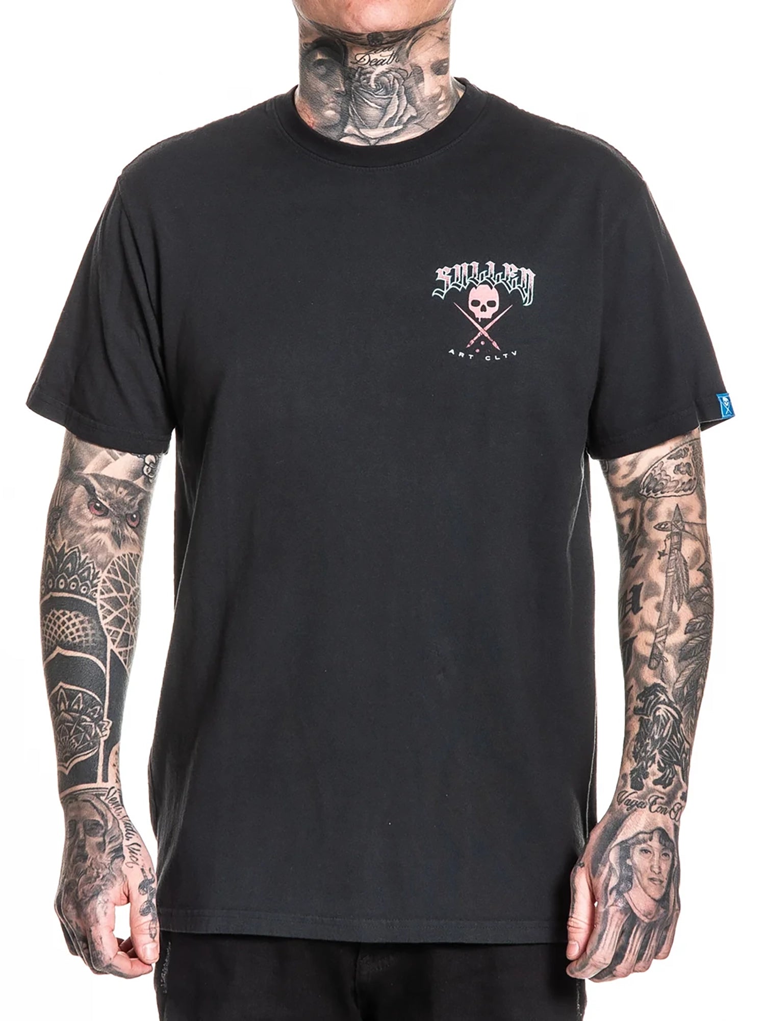 A black short-sleeve crewneck t-shirt with a small chest graphic featuring a skull and the word 'SILVER', worn by a tattooed model against a white background.