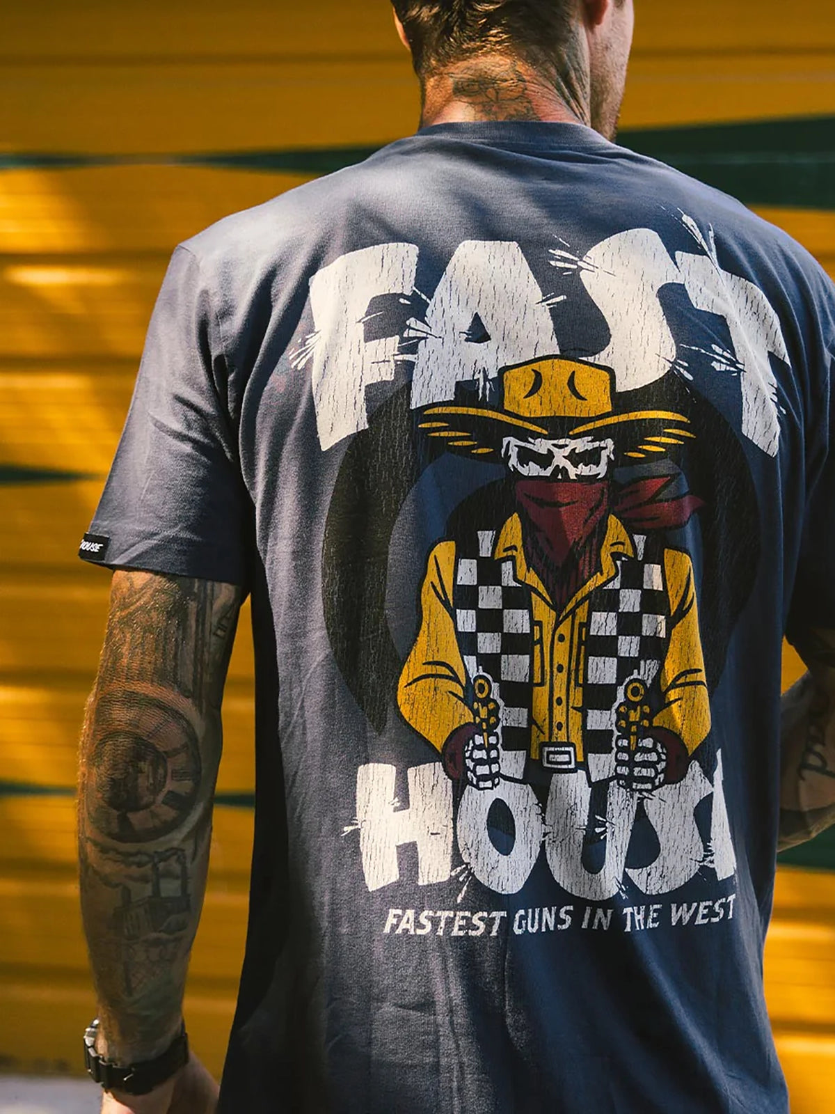 Fasthouse Men's Hyde Graphic T-shirt in Indigo, lifestyle view showing the back graphic