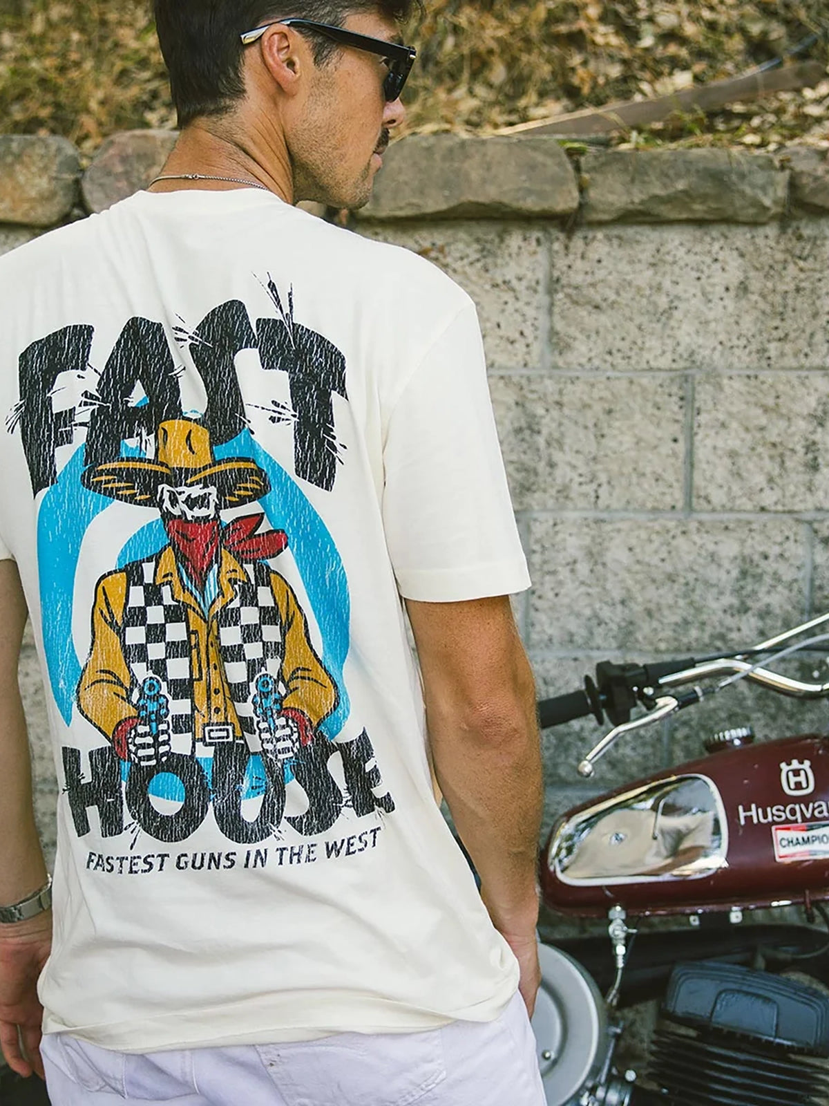 Fasthouse Men's Hyde Graphic T-shirt in Natural, lifestyle view showing the back graphic