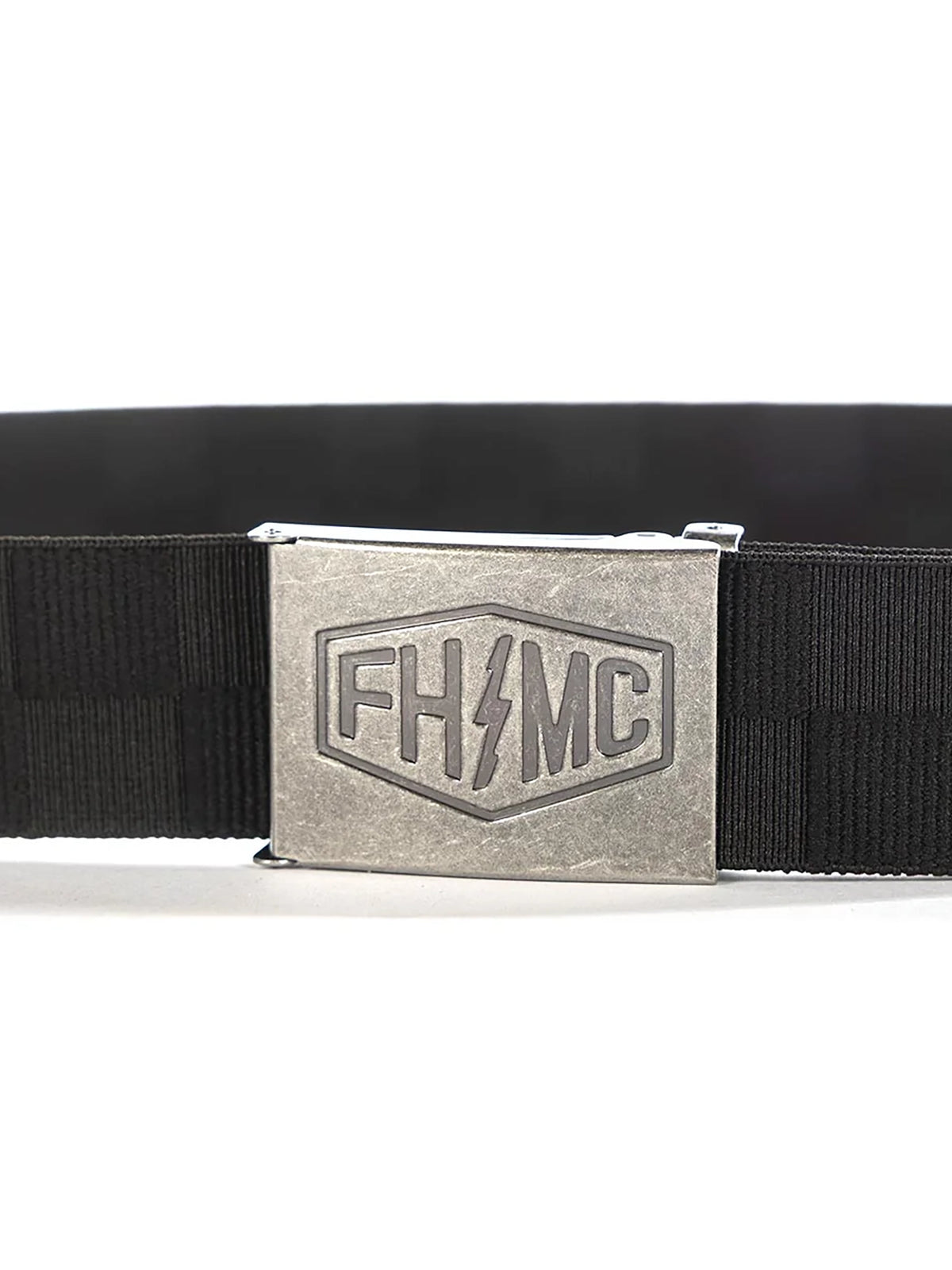 Metal FHMC buckle on Fasthouse Rapid Stretch Belt with debossed logo