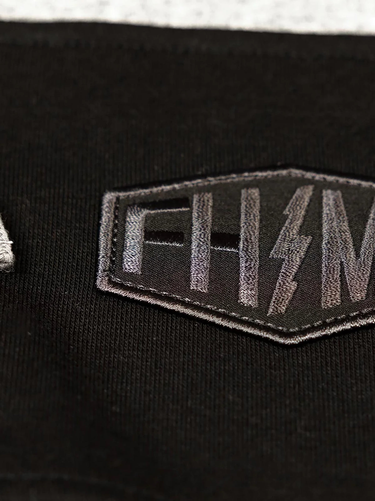 Fasthouse Men's Rapid Zip-Up Hoodie in Heather Gray/Black, close-up of the front chest graphic