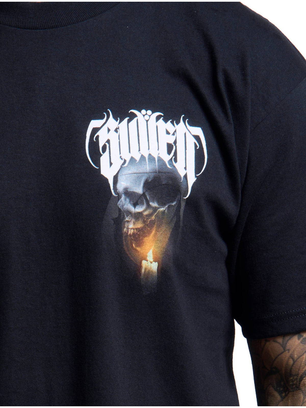 Close-up of the small Last Light skull and candle chest graphic on black cotton