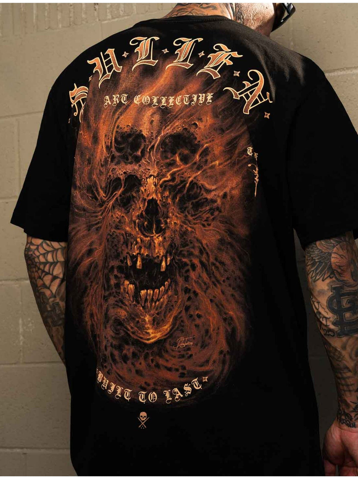 Styled back view of the Sullen Revenant Premium Jet Black T-shirt with ember-toned revenant artwork