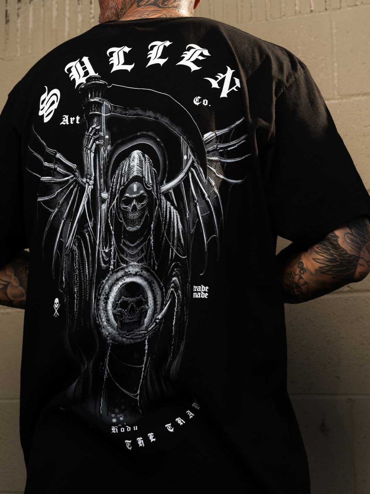 Back lifestyle view of the Sullen Hodu Reaper premium tee and large monochrome artwork