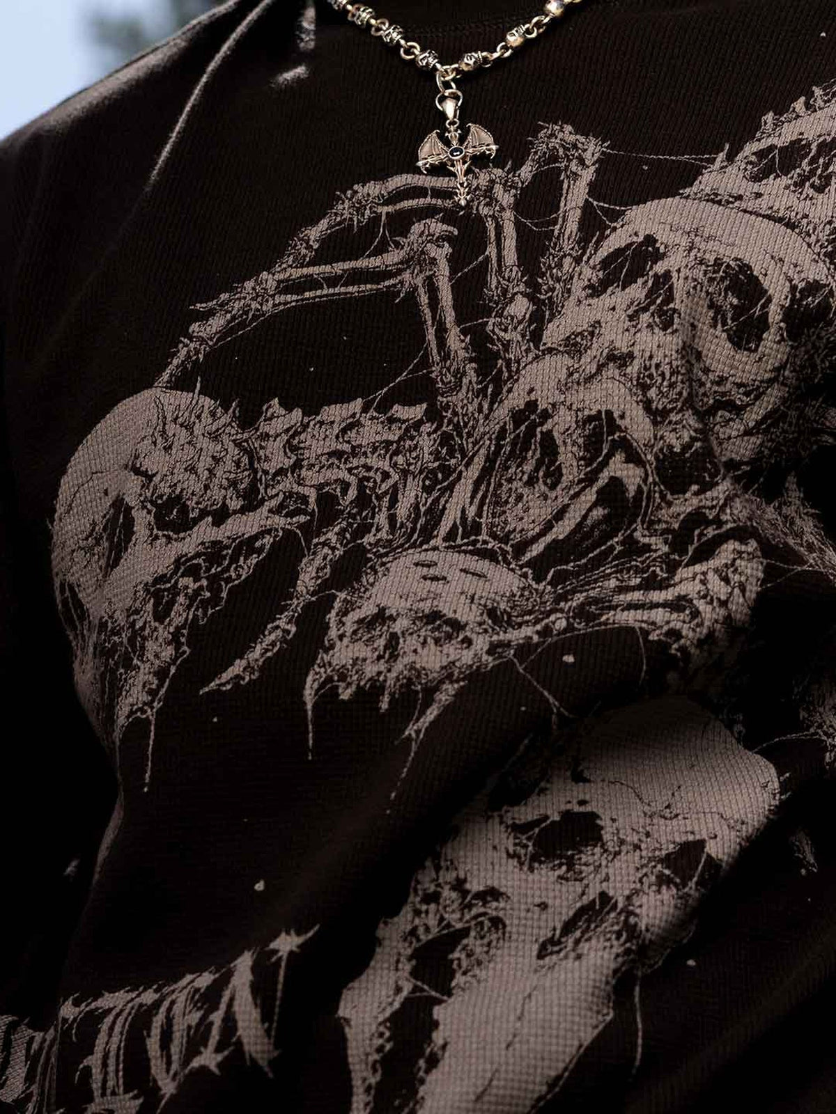 Sullen Scorpion thermal, outdoor close-up of skeletal scorpion print and waffle-knit fabric