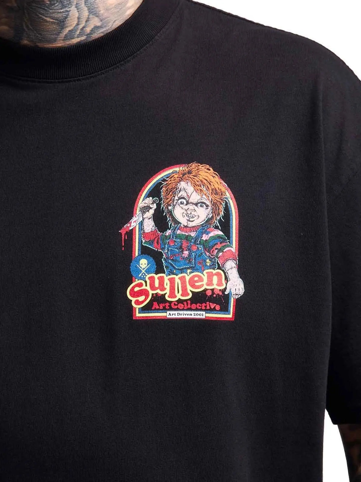 Close-up of the Wanna Play doll chest graphic